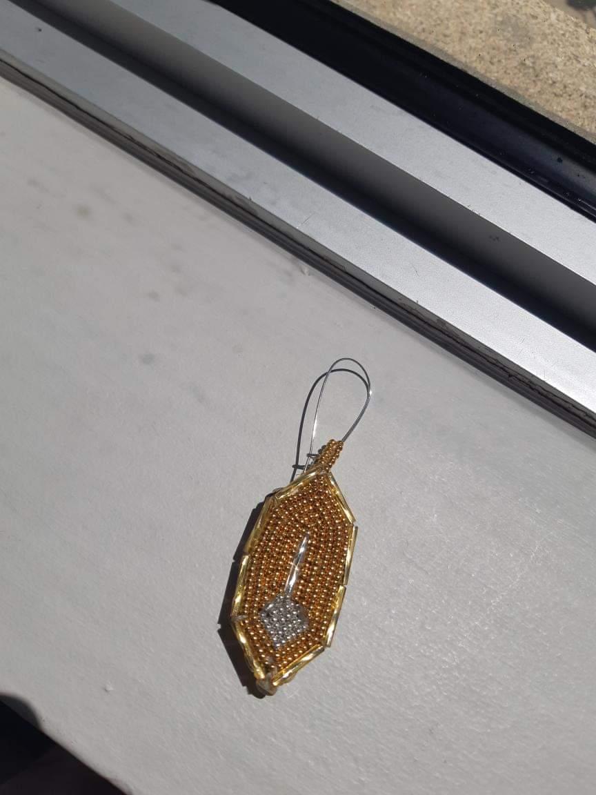 Gold and silver feather pendant