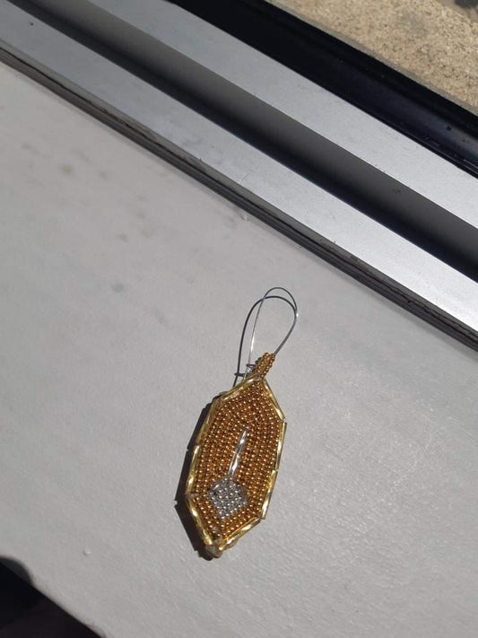 Gold and silver feather pendant